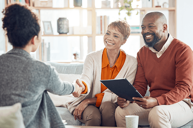 Couple reviewing estate planning documents with attorney